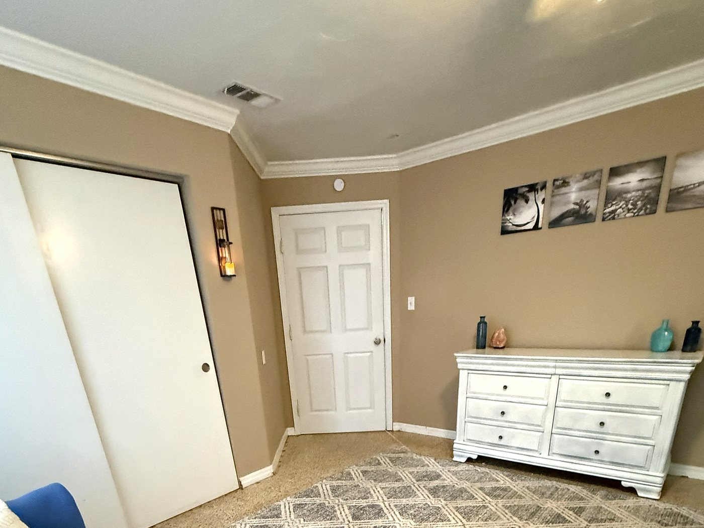 Bedroom closet wall with fresh paint and crown moulding