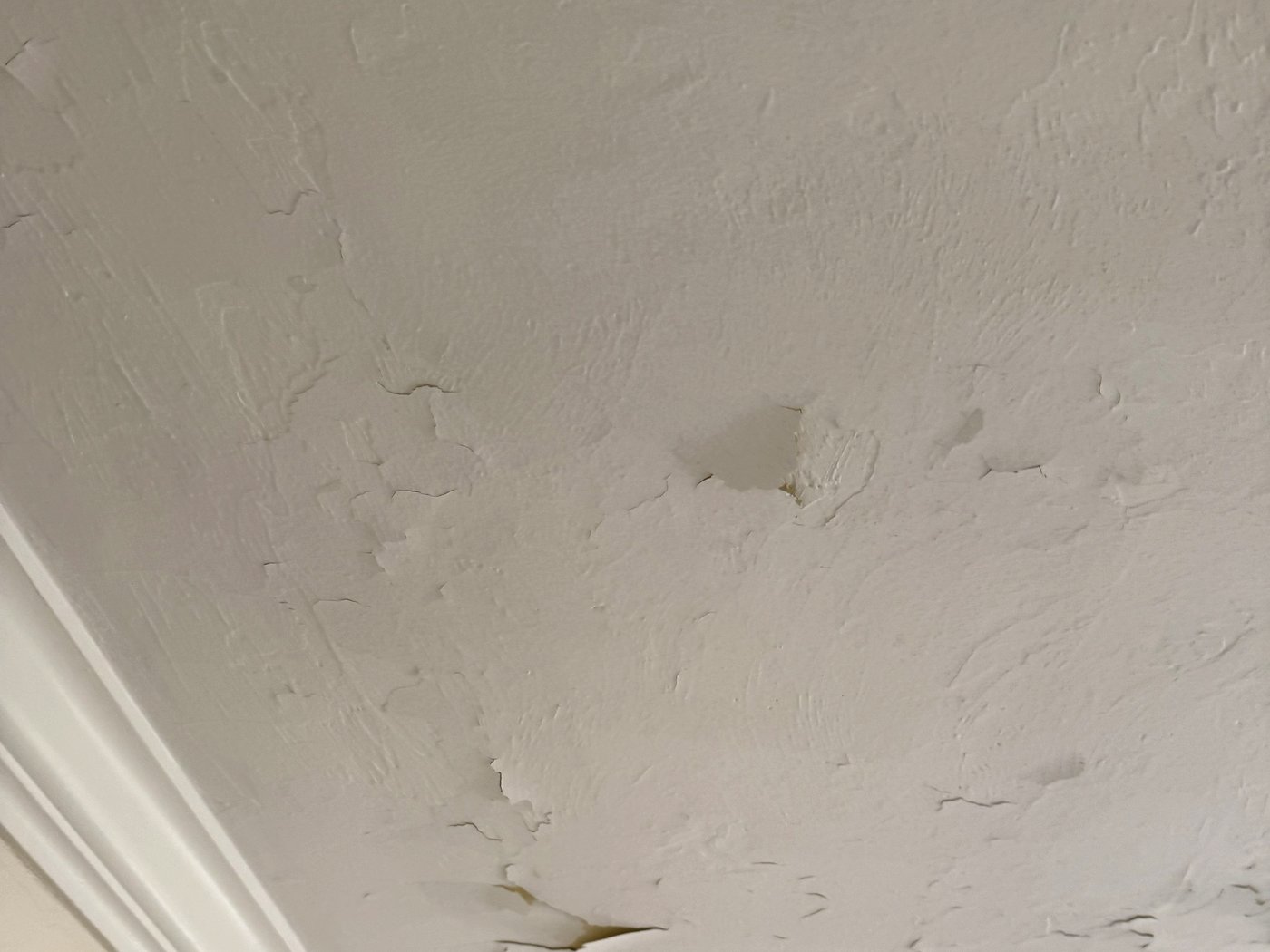 Ceiling peeling in sheets around an air vent