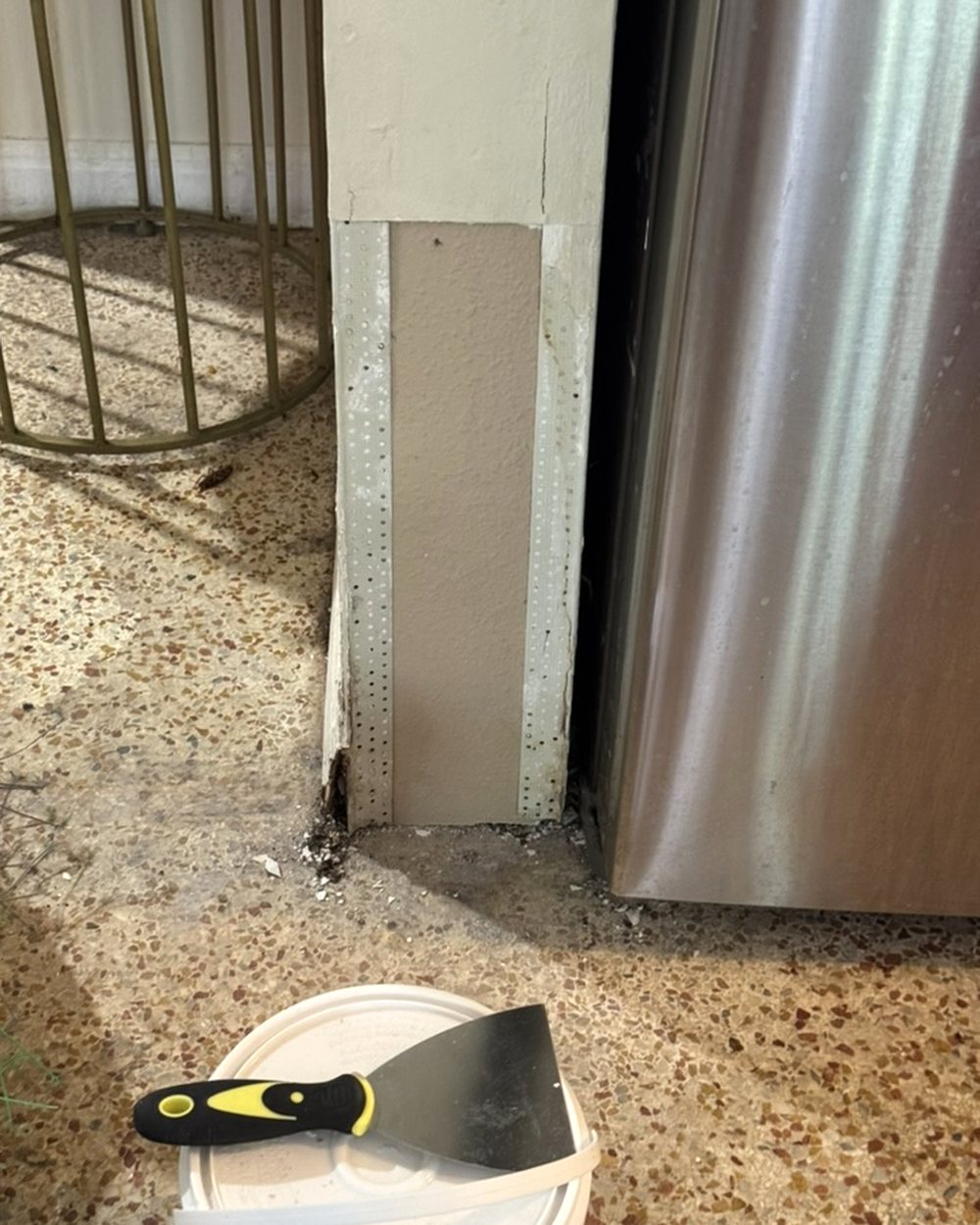 A new piece of drywall set into the damaged corner