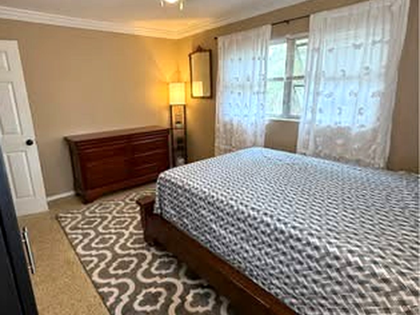 Finished master bedroom with a smooth painted ceiling and fresh walls