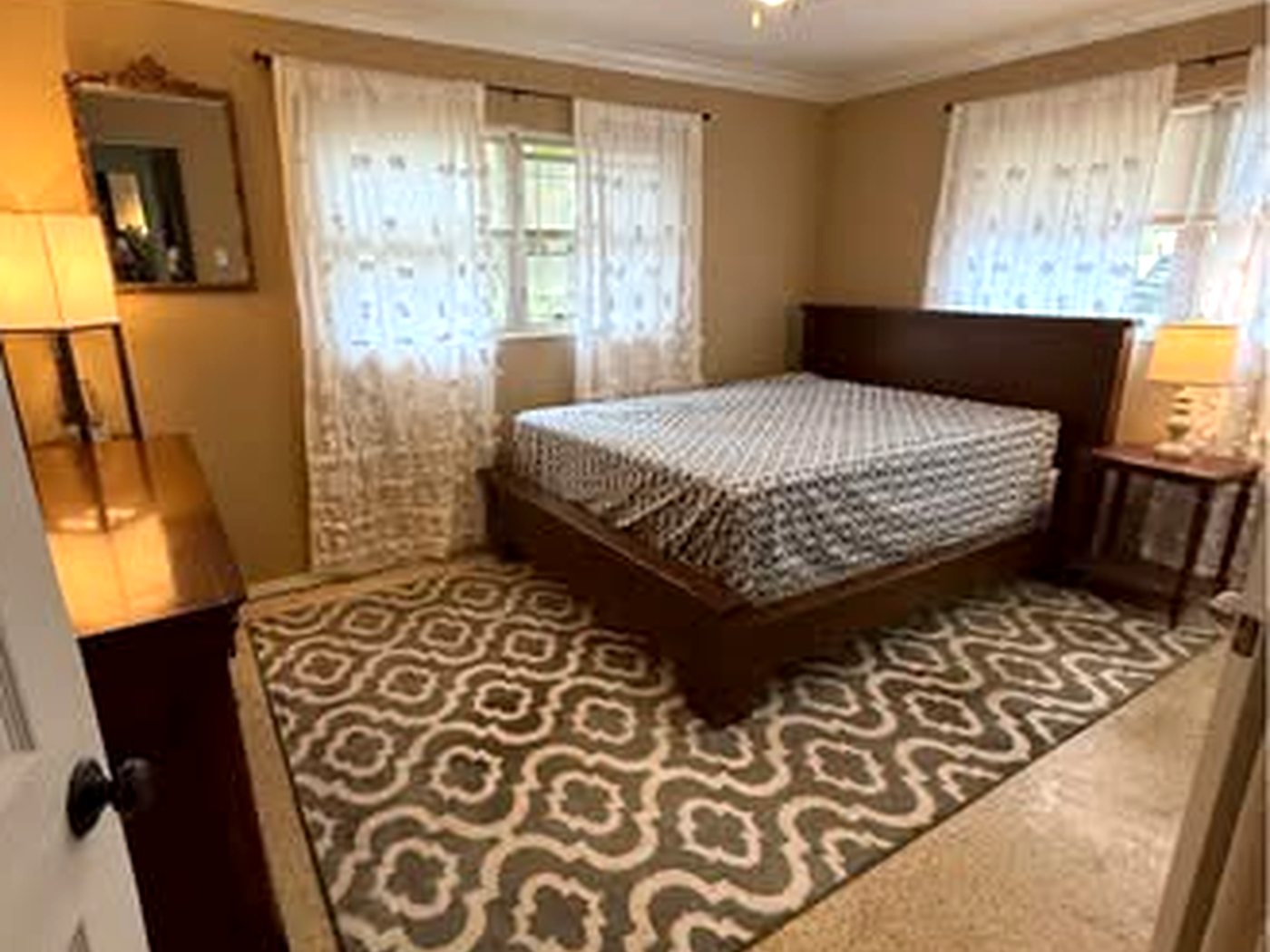 Finished bedroom with a smooth painted ceiling